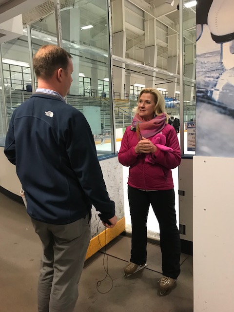 Two Adults Talk At Entrance To Rink